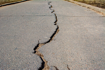 A huge long crack on an asphalt road