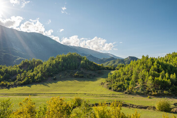 Obraz premium Beautiful mountain valley with gentle hills and agricultutal filds