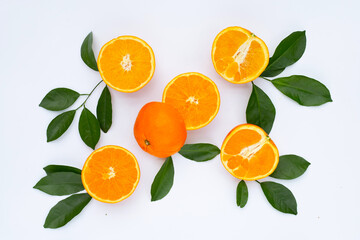 Orange fruit with green leaves on white background.