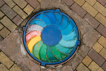 Colored manhole cover on the street