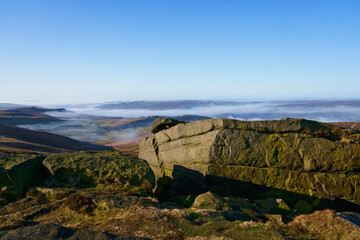 From the top of Stanage Edge mist lingers in the Derbyshire valleys.