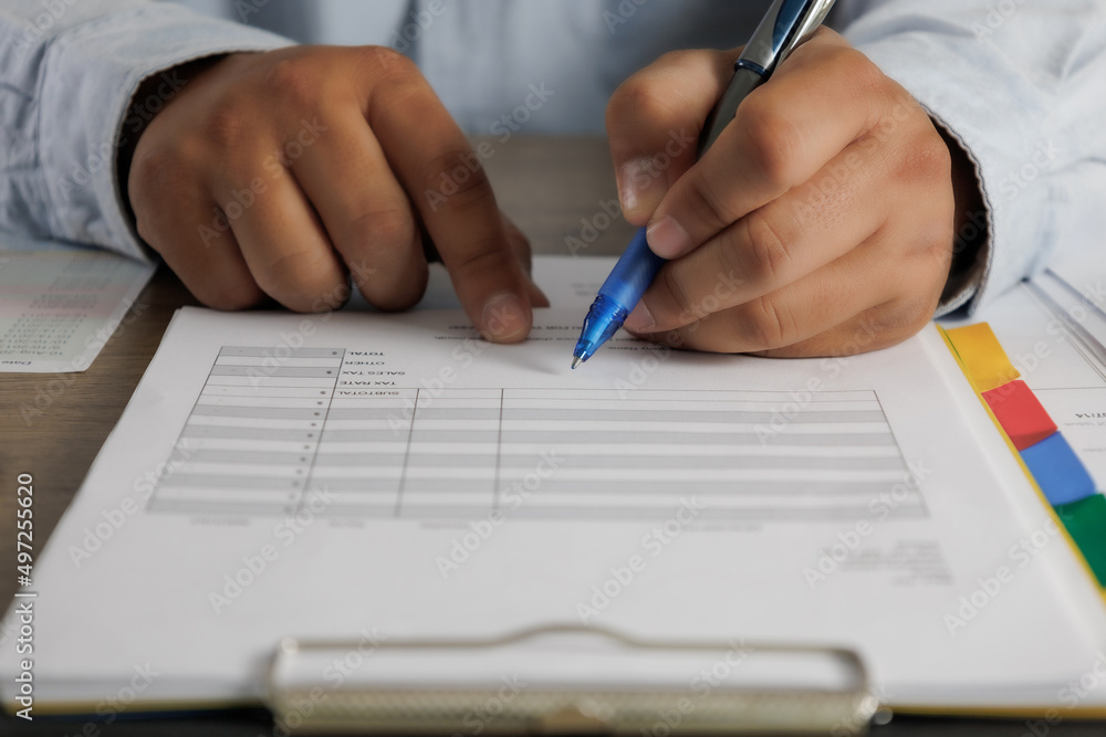 Poster businessman working reading documents signing contract on paper business document working on laptop 