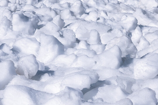 The texture of the snow under the rays of the sun. Snow torros. Ice.