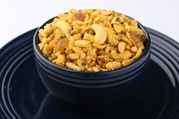 Indian Namkeen Snacks served in ceramic bowl & plate OR Indian traditional Namkeen Food Navratan Mixture or Navratna Mix Namkeen Also Know as Nimco, Namkin, Mixture or Nimko