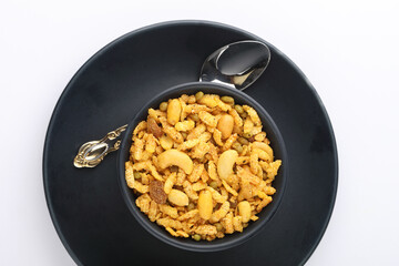 Indian Namkeen Snacks served in ceramic bowl & plate OR Indian traditional Namkeen Food Navratan Mixture or Navratna Mix Namkeen Also Know as Nimco, Namkin, Mixture or Nimko D