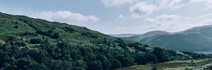 Naklejka premium Ancient woodland and landscaped glades near Waterfall at Aira Force near Ullswater, Cumbria. Lake District National Park, UK, banner size