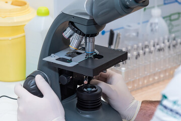 Medical laboratory, scientist hands using microscope for chemistry ,biology test samples,examining liquid,Doctor equipment,Scientific and healthcare research.