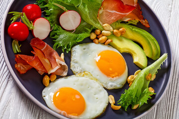 fried eggs, lettuce, avocado, radish, peanuts, ham
