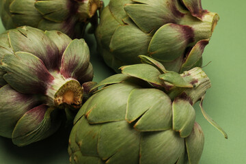 Raw food. Green and fresh artichokes on colourful background. Healthy life style. Mock-up.