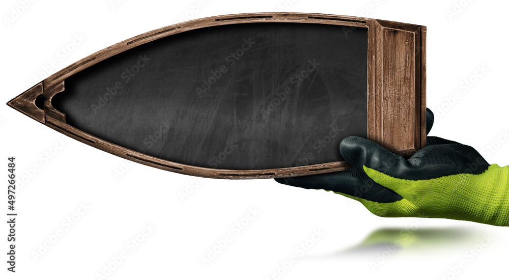 Poster hand with protective work gloves of a manual worker holding a small wooden boat with a blank blackbo