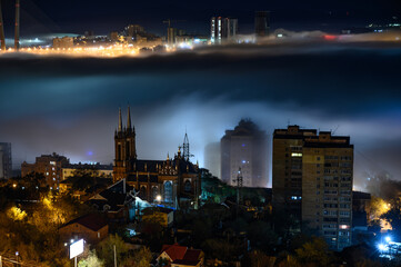Fototapeta na wymiar Cityscape night view. Fog over the city.