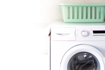 White washing machine and basin for clothes. Laundry room.