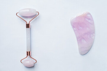 Roller marble facial massagers on white background..