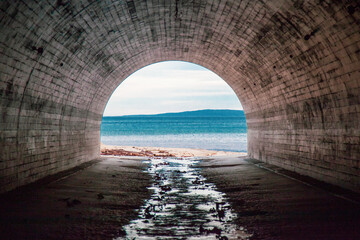 Beautiful view of the sea from under an arch tunnel