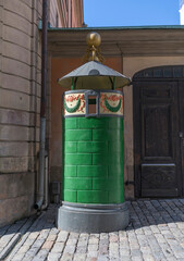 Fototapeta na wymiar Famous color full urinal in the old town Gamla Stan a sunny spring day in Stockholm