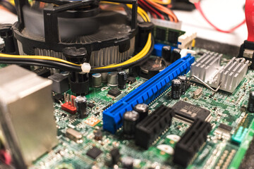 Close-up of a motherboard being restored by an IT technician