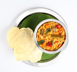 Sambar Rice - Tasty and popular south indian recipe served in a ceramic bowl with appalam or papad