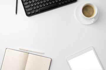 Office desk with laptop, blank notebook and coffee cup