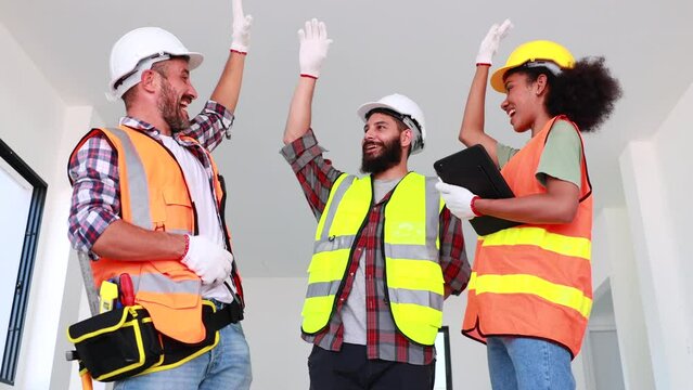 Professional Mechanical Engineer and construction team at house project underconstruction site. Hands meeting together in line. Unity and teamwork concept.