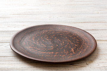 Perspective view of empty plate on wooden background. Empty space for your design