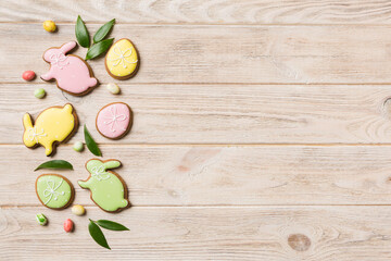holiday preparation Multi colors Easter eggs with cookies on colored background . Pastel color Easter eggs. holiday concept with copy space
