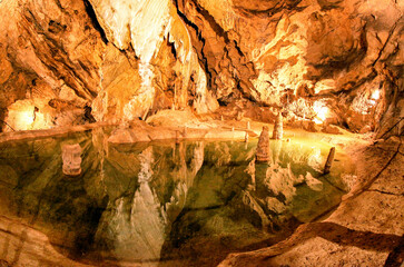 Colorful lake and stalactites and stalagmites in Belianska cave in Slovakia