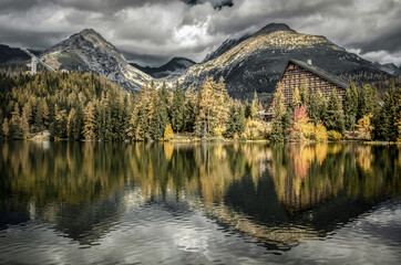 Obraz premium Reflection of peaks on water surface of tarn Strbske pleso in High Tatras mountain at Slovakia