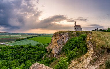 Fototapeta na wymiar Historic roman church on the hill over village Drazovce at Slovakia