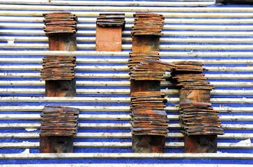 Roof tiles in piles on a roof ready to be laid on the battens by a roofing contractor.