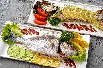 Fresh sea fish with lemon on plate