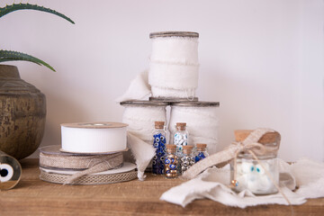 Work area, design tools, design films, adhesive tape, green cactus, wooden shelf, fabric film