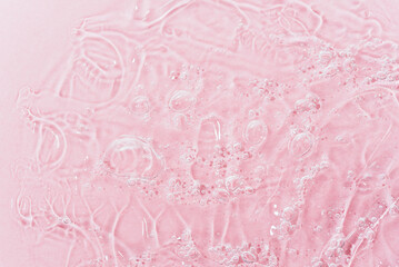 Close up macro Aloe vera gel cosmetic texture pink background with bubbles. Lemongrass gel skincare product. antibacterial liquid with aloe vera, moisturizing. Safe and environmental friendly.