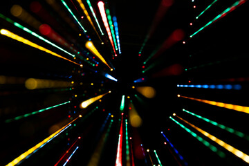 Long exposure abstract colorful led lights motion blur effect. A beam of light scattered around. Light burst, party laser lights, space concept.
