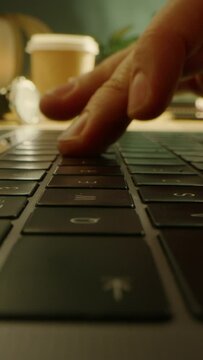 Close-up Macro Shot: Person Types on the Laptop Keyboard. Slow Motion Video Footage with Vertical Screen Orientation 9:16