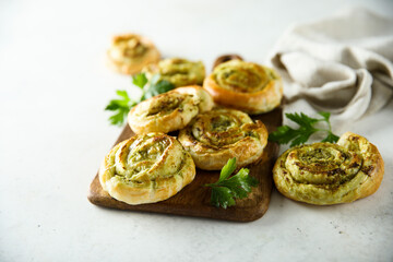 Homemade puff pastry swirls with pesto sauce
