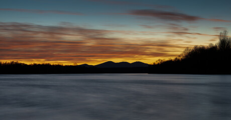 Mountain Motajica and Sava river at twilight with colorful clouds