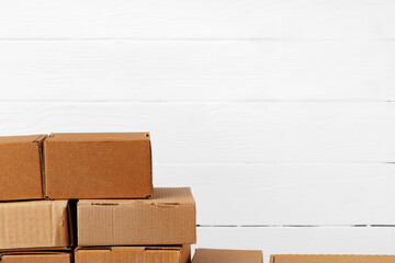 Group of cardboard boxes against white wooden wall