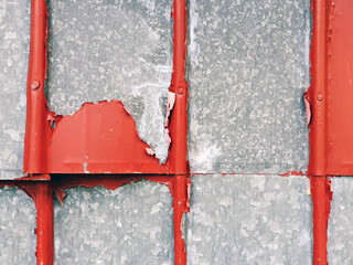 red peeling paint on metal wall