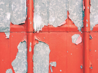 red peeling paint on metal wall