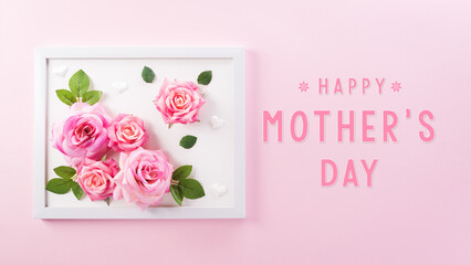 Happy Mother's Day decoration concept made from rose flower and picture frame with the text on pink...