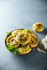 Homemade puff pastry swirls with pesto sauce