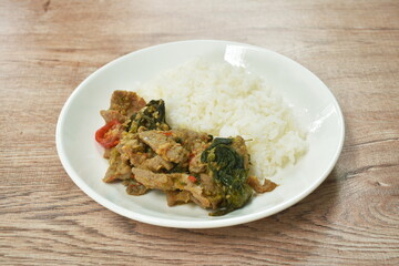spicy fried slice kurobuta black pork with basil on rice in plate