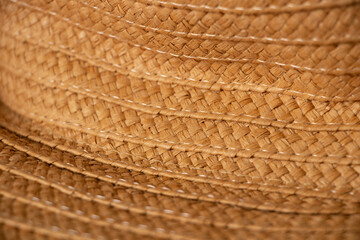 Fototapeta na wymiar Yellow trendy straw women's hat as a background ,fashion and trend,headwear