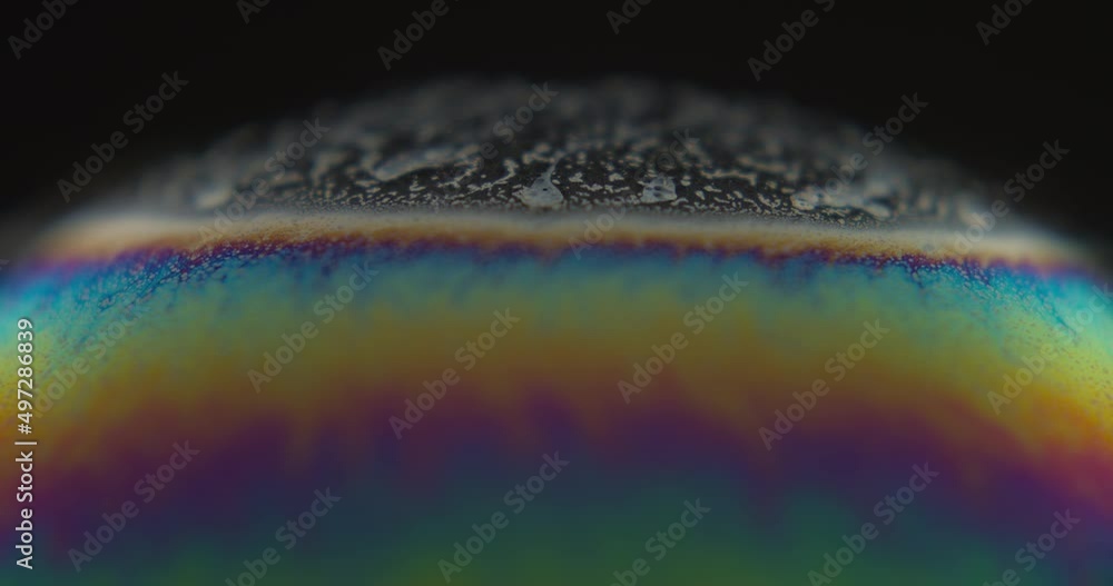 Aufkleber macro close up static shot of soap bubble surface. black background. shallow focus