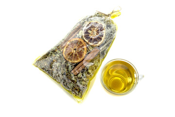 Collection useful herbs for tea in a package and a cup of brewed tea
