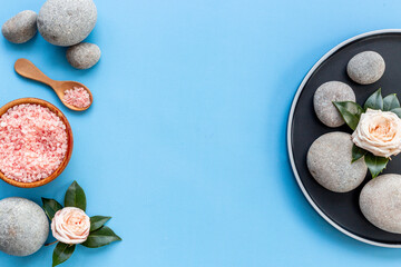 Relax background - spa stones with roses and sea salt, top view