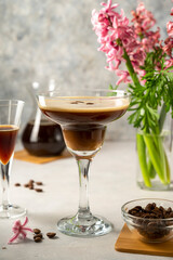 Espresso Martini cocktail drink. Alcohol cocktail with foam and coffee beans. Party drinks.