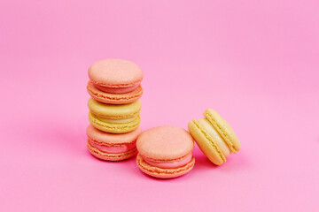 Beautiful multi-colored pastel-colored macaroons on a pink background with a place for writing and cutting. Minimalism.