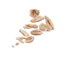 Dry oat flakes levitate on a white background