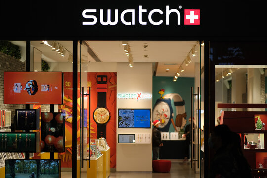 Shanghai,China-Jan.1st 2022: facade of Swatch watch store exterior and brand logo at night. Swiss watchmaker 